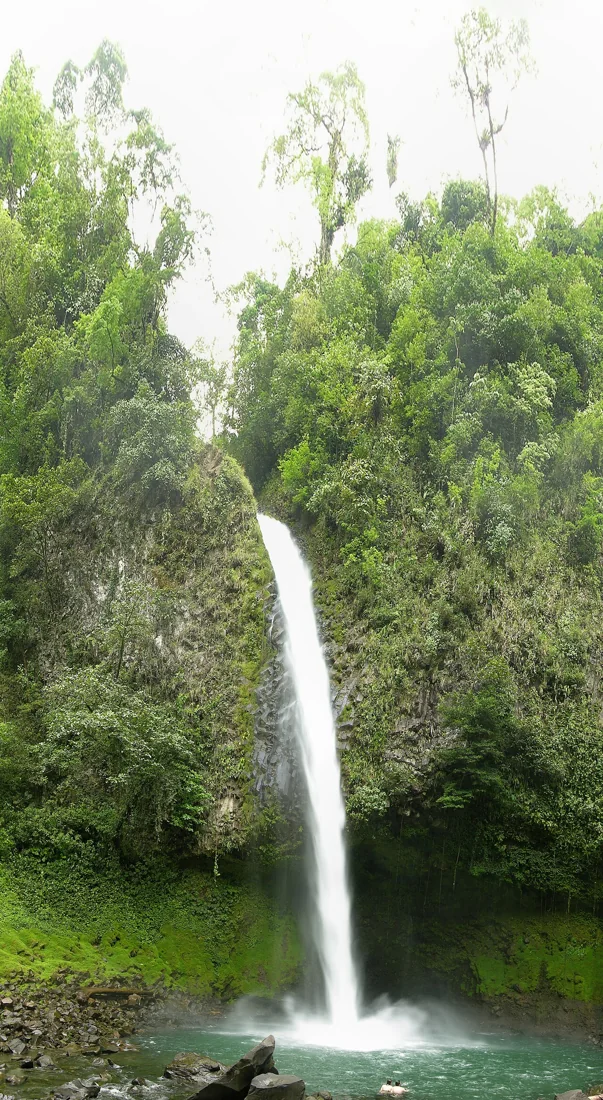 La Fortuna Waterfall seen from the top as the river continues toward the El Salto swimming hole in Costa Rica